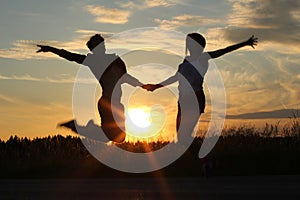 Teenage sisters, doing exercises at sunset