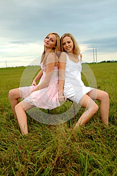 Teenage sisters in field