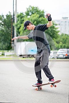 Teenage skateboarder standing