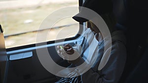 Teenage with smartphone inside the train.