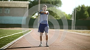 Teenage sport boy engaged stadium stretching