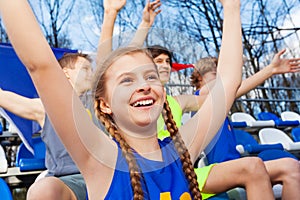 Teenage sports fan celebrating win at the tribune