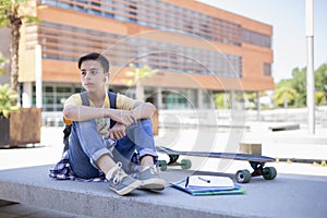 Teenage student boy listening to music outdoors