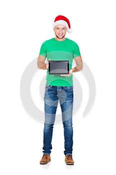 Teenage student in a Christmas hat holding a tablet