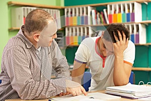 Teenage Student In Classroom With Tutor