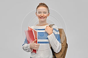 Teenage student girl with school bag and notebooks