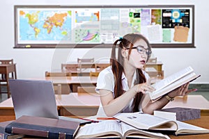 Teenage student studying in class seriously