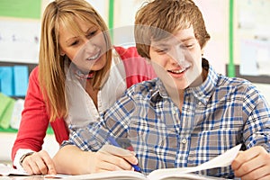 Teenage Student Studying With Teacher