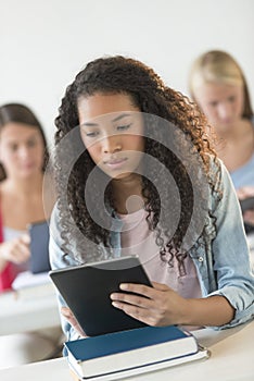Teenage Student Using Digital Tablet At Desk