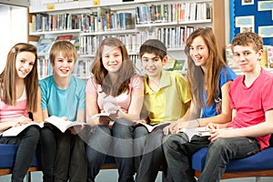 Teenage Students In Library Reading Books photo