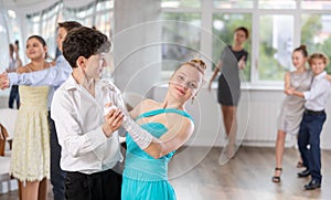 Teenage students rehearsing ballroom dance while preparing for college festive event
