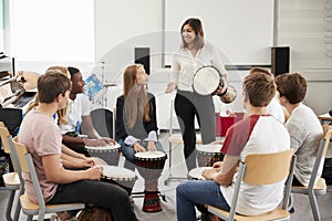 Teenage Students Studying Percussion In Music Class