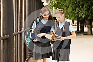 Teenage students in stylish school uniform