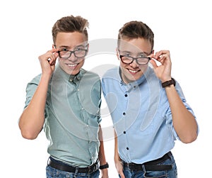 Teenage twin brothers with glasses on white