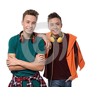 Teenage twin brothers with headphones on white