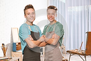 Teenage twin brothers posing in workshop