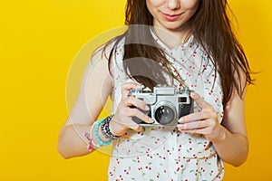 Teenage woman holding a retro film camera