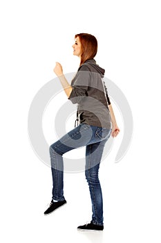 Teenage woman trying to trample something