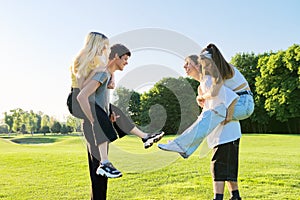 Teenage youth having fun in the park, happy laughing friends.