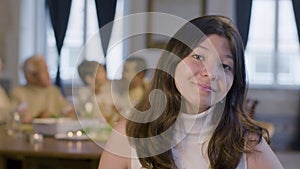 Teenaged dark-haired girl looking at camera and smiling