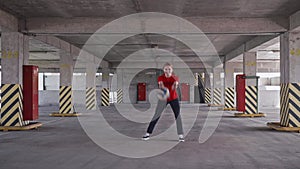 Teenaged girl catches a volleyball ball and then throw in back. Outdoor activities.