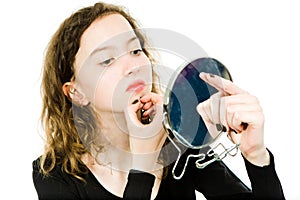 Teenaged girl checking skin in mirror - chin