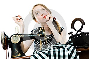 Teenaged girl dressmaker thinks and plan before will use manual sewing machine