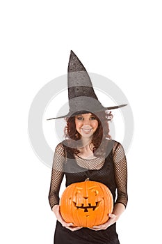 Teenaged girl in Halloween costume with pumpkin