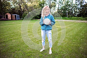 Teenaged girl outdoors with a volleyball