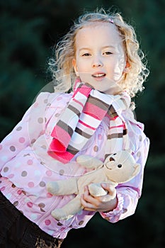 Teenaged girl posing with teddy bear- autumn time - dots purple jacket