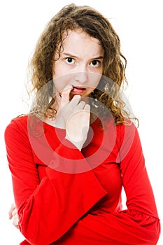 Teenaged girl in red dress having doubts and stress