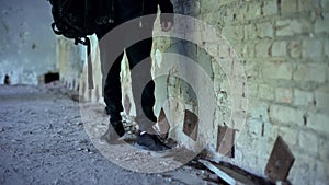 Teenager in abandoned house, comfortable shoes for extreme adventures closeup