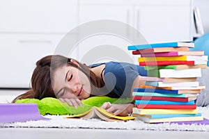 Teenager asleep by the book