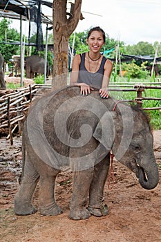 Teenager with baby elephant