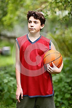 Teenager basketball palyer training with ball