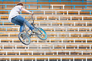 Teenager on a bicycle in a high jump