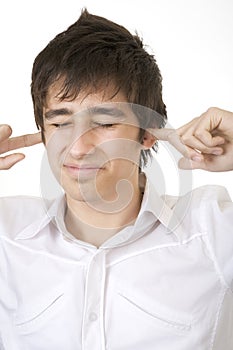 Teenager blocking his ears photo