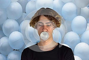 Teenager blows bubbles with chewing gum