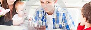 Teenager blows out the candles on a birthday cake