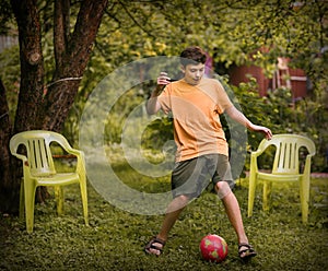 Teenager boy with ball close up photo playing football