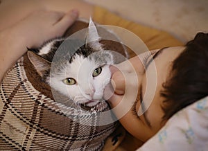 Teenager boy with cat kissing hug photo