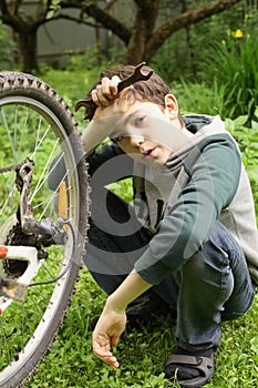 Teenager boy change bicycle tire weel camera