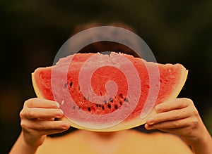 Teenager boy with cut water melon close up photo
