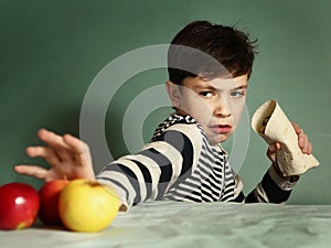 Teenager boy eat fastfood roll refuse fruit