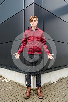 Teenager boy gesticulating doubt and question over urban background photo
