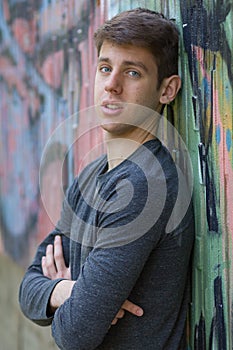 Teenager boy in grey shirt outdoors