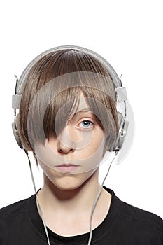 Teenager boy with hair over one eye and headphones