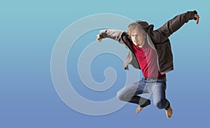 Teenager boy jumping dance movement on a colored blue background