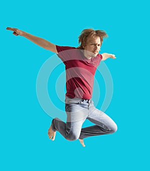 Teenager boy jumping dance movement on a colored yellow background