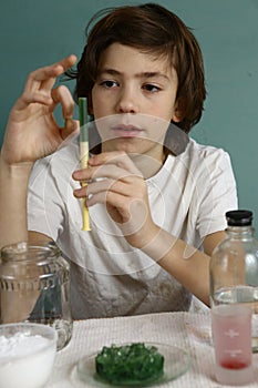 Teenager boy make chemical trick experiments with substances and reagents